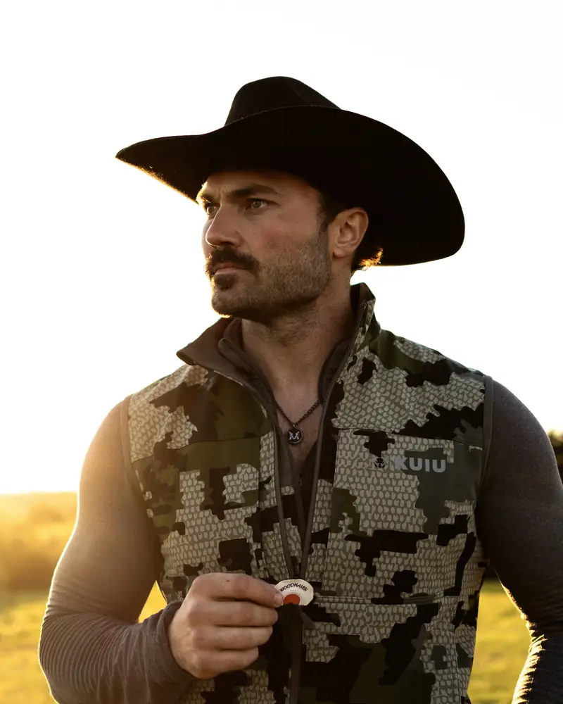 Steven McBee in a black cowboy hat at sunrise